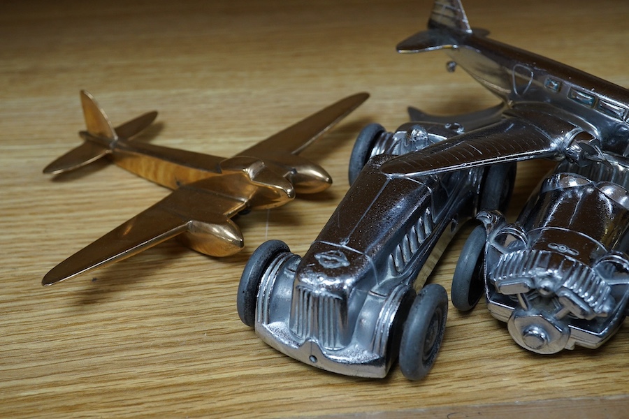 Four car mascots; an ‘Old Bill’ after Bruce Bainsfather, with cast signature to the rim of the helmet, three aircraft, including a stylised fighter plane, and a bomber, together with two chromed clockwork Gaiety Toy cars